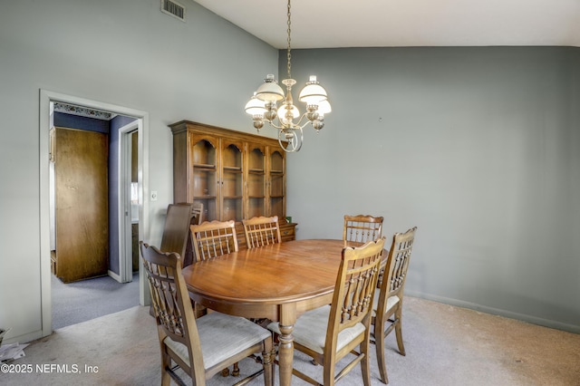 dining room with an inviting chandelier and light colored carpet