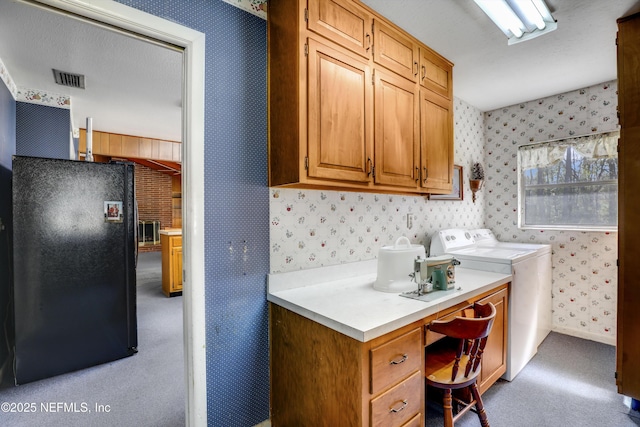 laundry area with light carpet and washing machine and clothes dryer