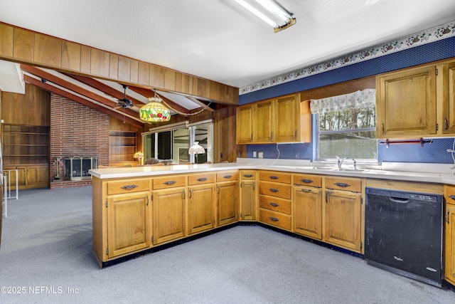 kitchen with lofted ceiling, sink, dishwasher, light colored carpet, and kitchen peninsula