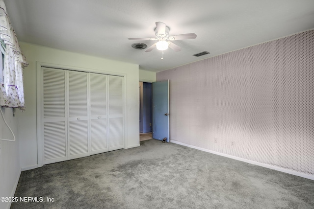 unfurnished bedroom with a closet, ceiling fan, and carpet