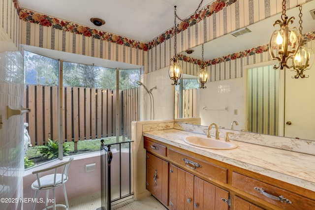 bathroom featuring an inviting chandelier and vanity