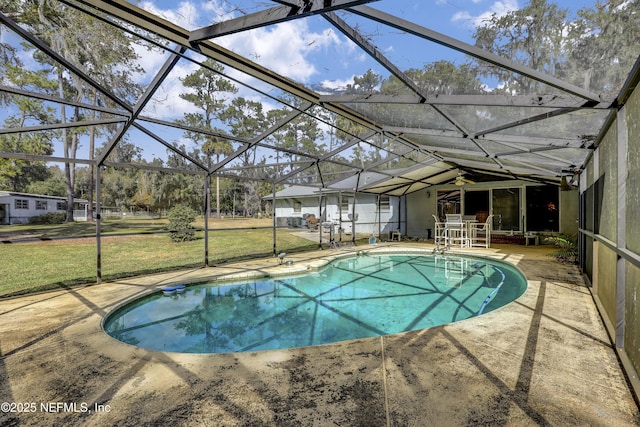 view of swimming pool with a yard, glass enclosure, and a patio area