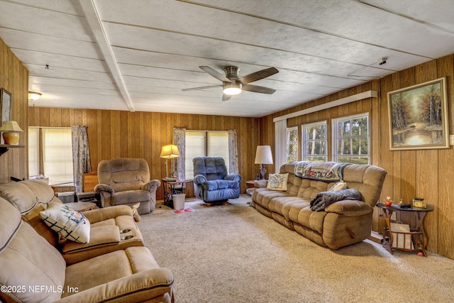 living room featuring carpet floors, ceiling fan, and wood walls