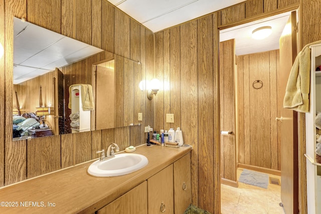 bathroom with vanity, tile patterned flooring, and wood walls