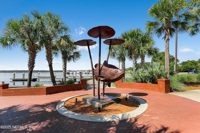 surrounding community featuring a dock and a water view