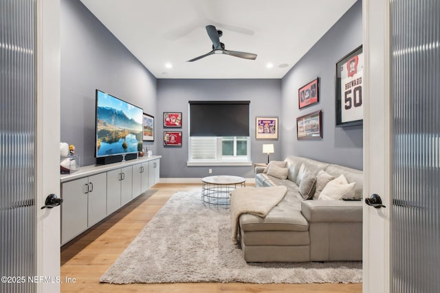 living room with ceiling fan and light wood-type flooring