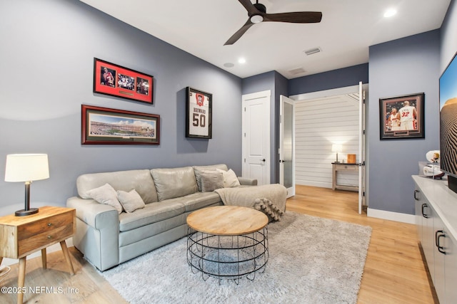 living room with ceiling fan and light hardwood / wood-style floors