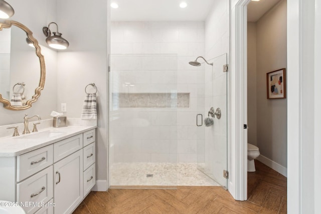 bathroom featuring vanity, parquet floors, toilet, and walk in shower