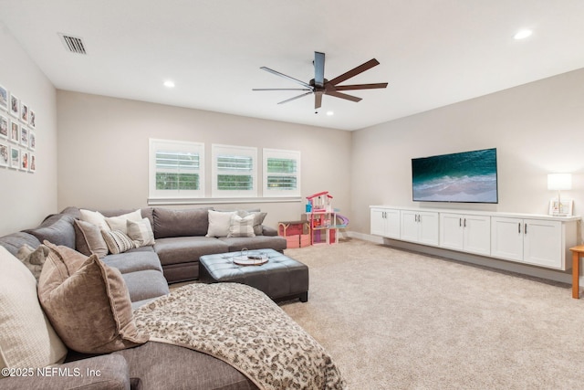 living room with light colored carpet and ceiling fan