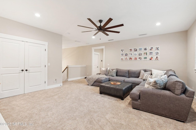 carpeted living room with ceiling fan