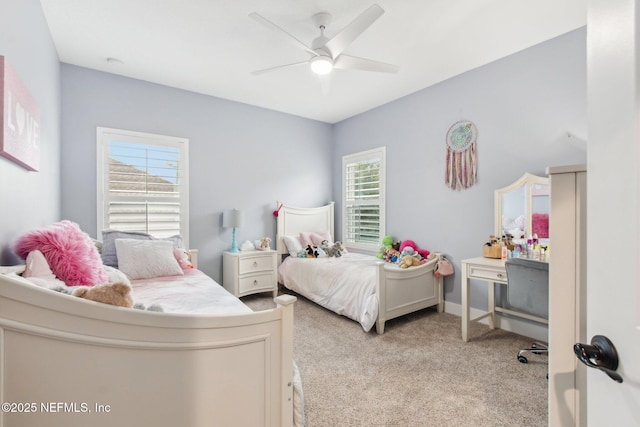 carpeted bedroom featuring ceiling fan and multiple windows