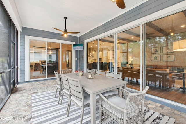 sunroom / solarium featuring ceiling fan