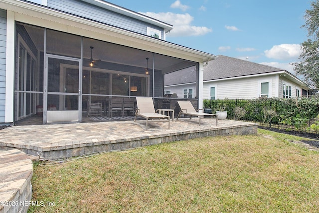 back of house with a yard, a patio area, and a sunroom