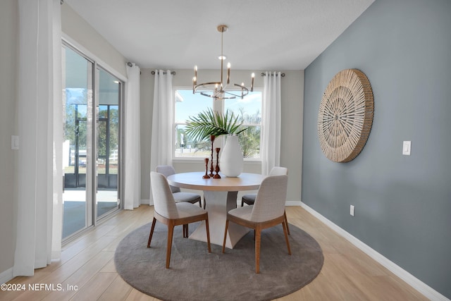 dining space featuring a chandelier and light hardwood / wood-style flooring