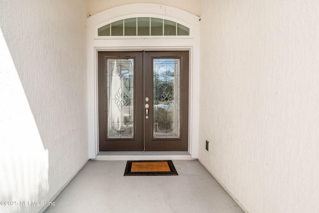 view of exterior entry featuring french doors