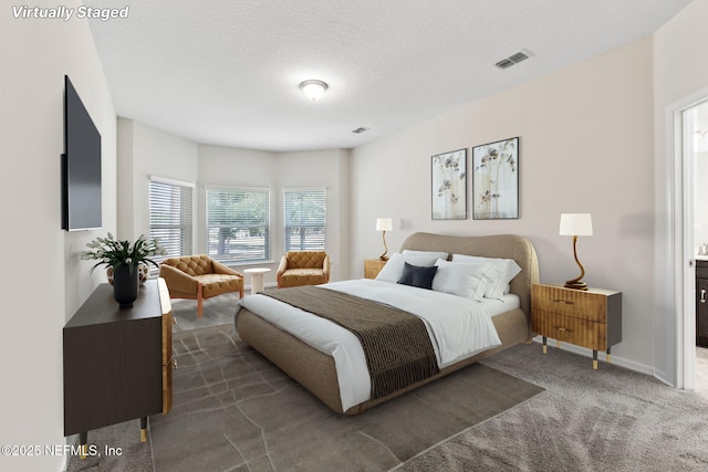 carpeted bedroom with a textured ceiling