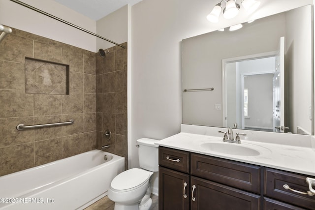 full bathroom with vanity, toilet, and tiled shower / bath