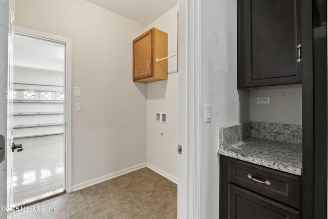 washroom featuring washer hookup and cabinets