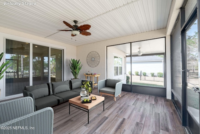 sunroom with wooden ceiling and ceiling fan