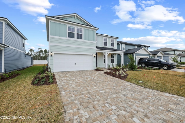 view of property featuring a garage and a front yard