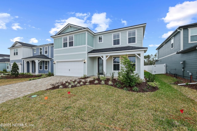 view of front of property with a garage and a front lawn