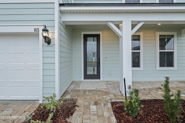 view of exterior entry with a garage