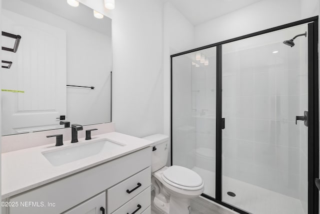 bathroom with vanity, toilet, and an enclosed shower