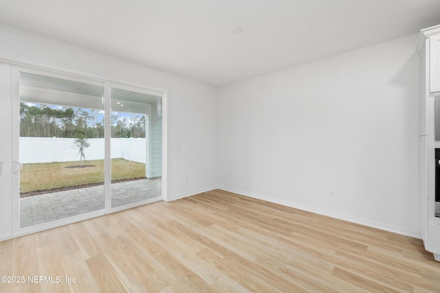 unfurnished room with light hardwood / wood-style flooring