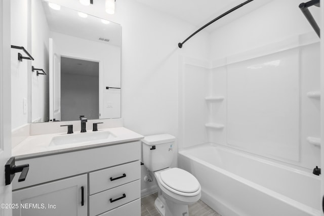 full bathroom featuring vanity, bathtub / shower combination, and toilet