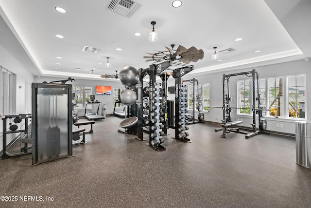 workout area featuring a tray ceiling