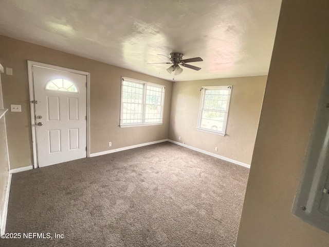 carpeted foyer entrance with ceiling fan