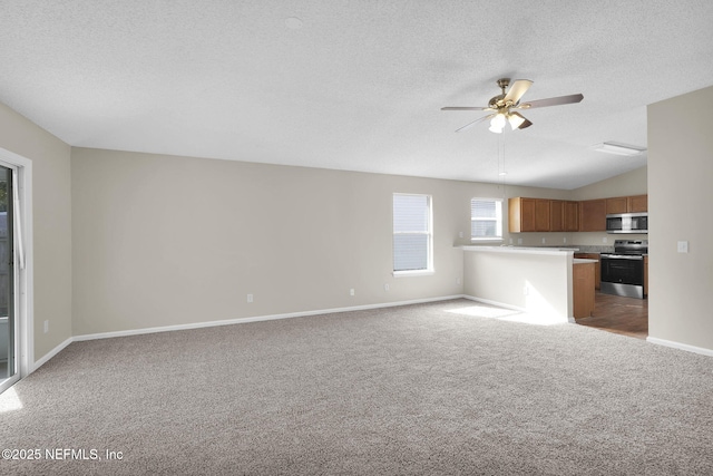 unfurnished living room featuring ceiling fan, lofted ceiling, light carpet, and a textured ceiling