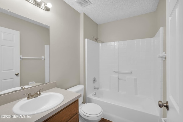 full bathroom with shower / bath combination, vanity, a textured ceiling, and toilet