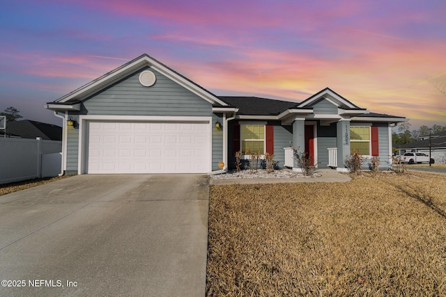 view of front of home with a garage and a lawn