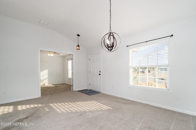 spare room with vaulted ceiling, carpet, and an inviting chandelier