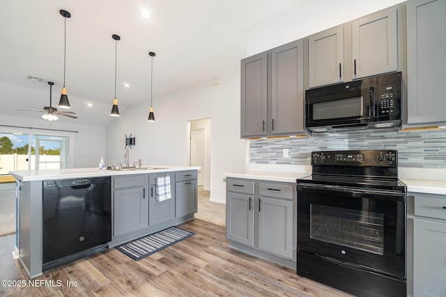 kitchen featuring gray cabinets, tasteful backsplash, sink, light hardwood / wood-style floors, and black appliances