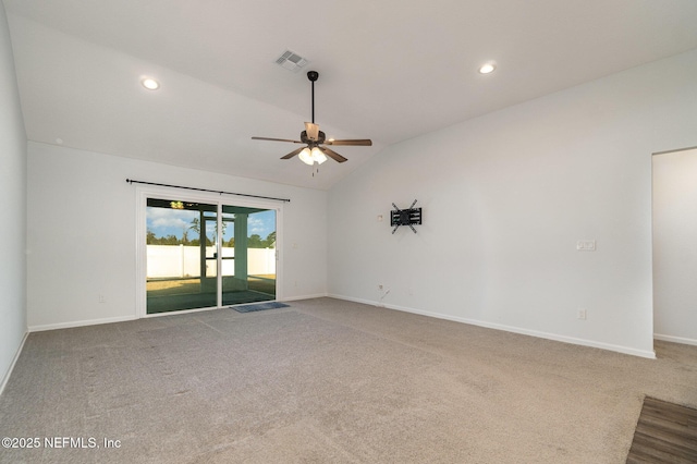 empty room featuring carpet floors, ceiling fan, and vaulted ceiling