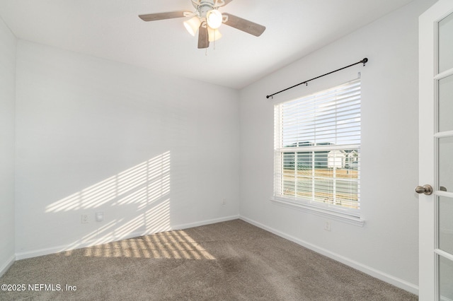 carpeted spare room with ceiling fan