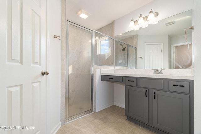 bathroom with vanity, a shower with shower door, and tile patterned floors