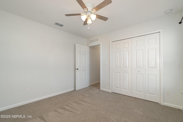 unfurnished bedroom with ceiling fan, carpet flooring, and a closet