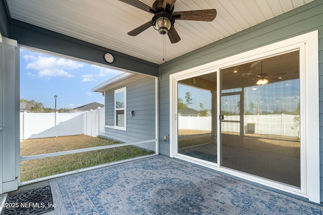 unfurnished sunroom featuring ceiling fan