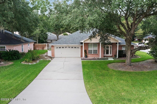 ranch-style house featuring a garage and a front lawn