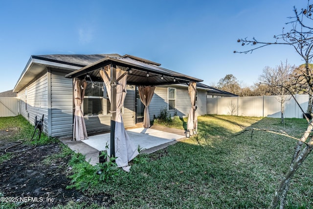 back of property featuring a yard and a patio