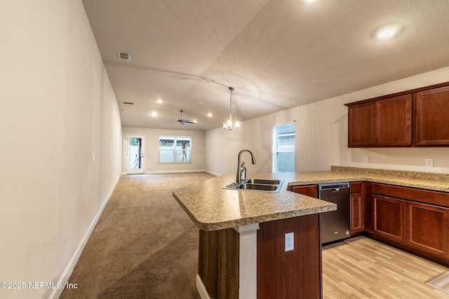 kitchen featuring dishwasher, decorative light fixtures, sink, kitchen peninsula, and a notable chandelier