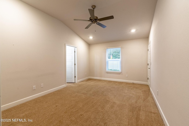 carpeted empty room with ceiling fan and lofted ceiling