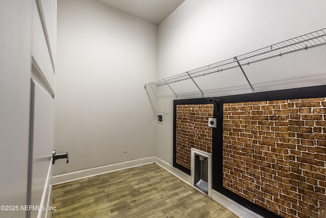 clothes washing area with hardwood / wood-style flooring, electric dryer hookup, and hookup for a washing machine