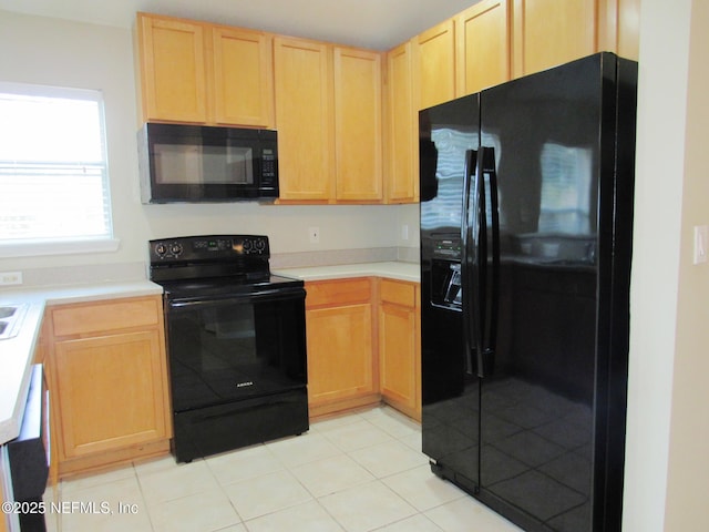 kitchen featuring light tile patterned floors, black appliances, light brown cabinetry, and light countertops