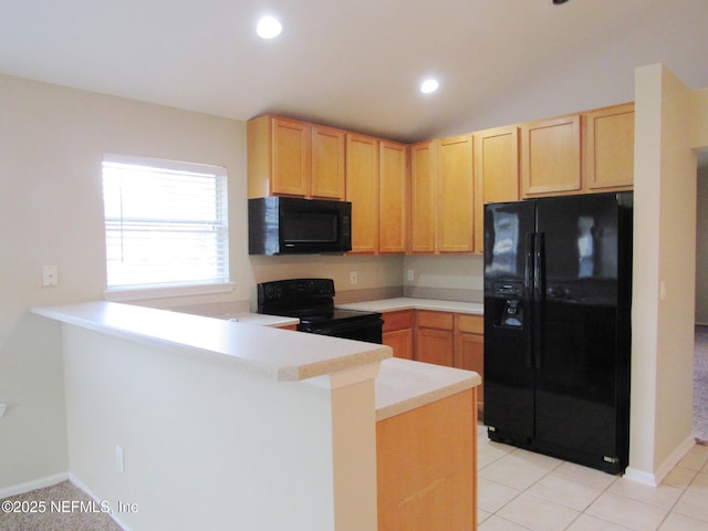 kitchen with a peninsula, light countertops, black appliances, light brown cabinets, and light tile patterned flooring