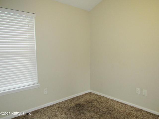 unfurnished room with carpet flooring and baseboards