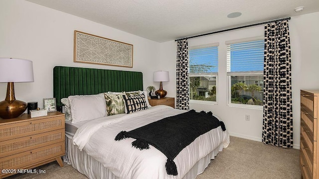 carpeted bedroom featuring a textured ceiling